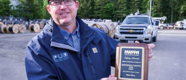 Josh Garlock holding a NWPPA Safety Award for PUD