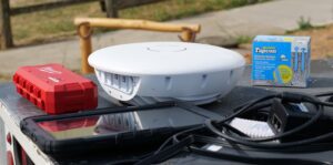 Close up of Calix Outdoor Wi-Fi Router sitting on the bed of a PUD utility truck
