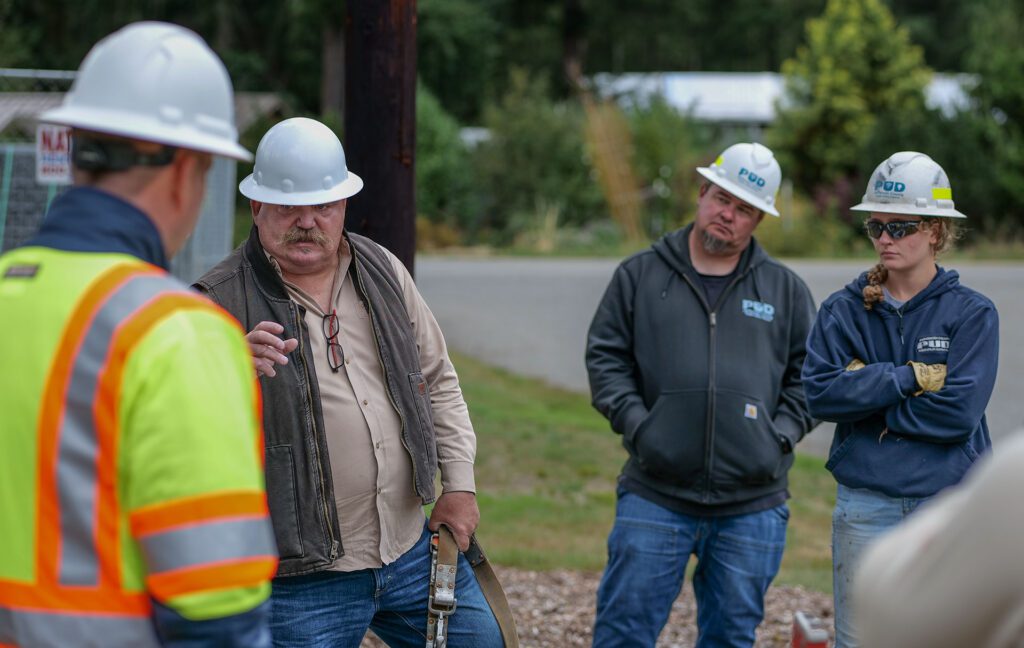 Instructor John Spain with Northwest Safety Service, addresses PUD staff gathered around the vault rescue space.